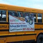 A school bus outside of Kenai Central High School advertises driver positions on Wednesday, Aug. 10, 2022, in Kenai, Alaska. (Ashlyn OHara/Peninsula Clarion)