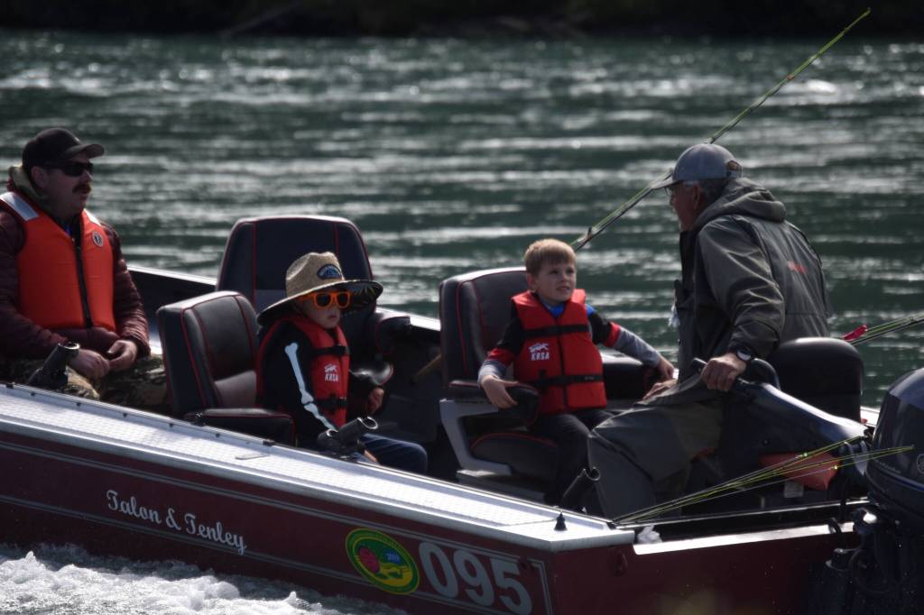 Children ride a fishing boat onto the Kenai River during the Kenai River Junior Classic in Soldotna, Alaska, on Aug. 10, 2022. (Jake Dye/Peninsula Clarion)