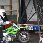Ziana Flores of the Fearless Flores Family rides into the Globe of Death at the Kenai Peninsula Fair on Aug. 12, 2022 in Ninilchik, Alaska. (Jake Dye/Peninsula Clarion)