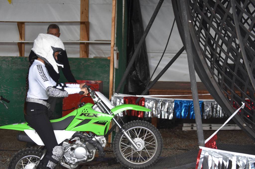 Ziana Flores of the Fearless Flores Family rides into the Globe of Death at the Kenai Peninsula Fair on Aug. 12, 2022 in Ninilchik, Alaska. (Jake Dye/Peninsula Clarion)