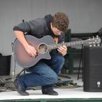 Homer youth Silas Jones performs on the Inlet Stage at the Kenai Peninsula Fair on Aug. 12, 2022, in Ninilchik, Alaska. (Jake Dye/Peninsula Clarion)