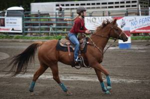 Evelyn Cooley competes in the barrel race at the Kenai Peninsula Fair on Aug. 12, 2022, in Ninilchik, Alaska. (Jake Dye/Peninsula Clarion)