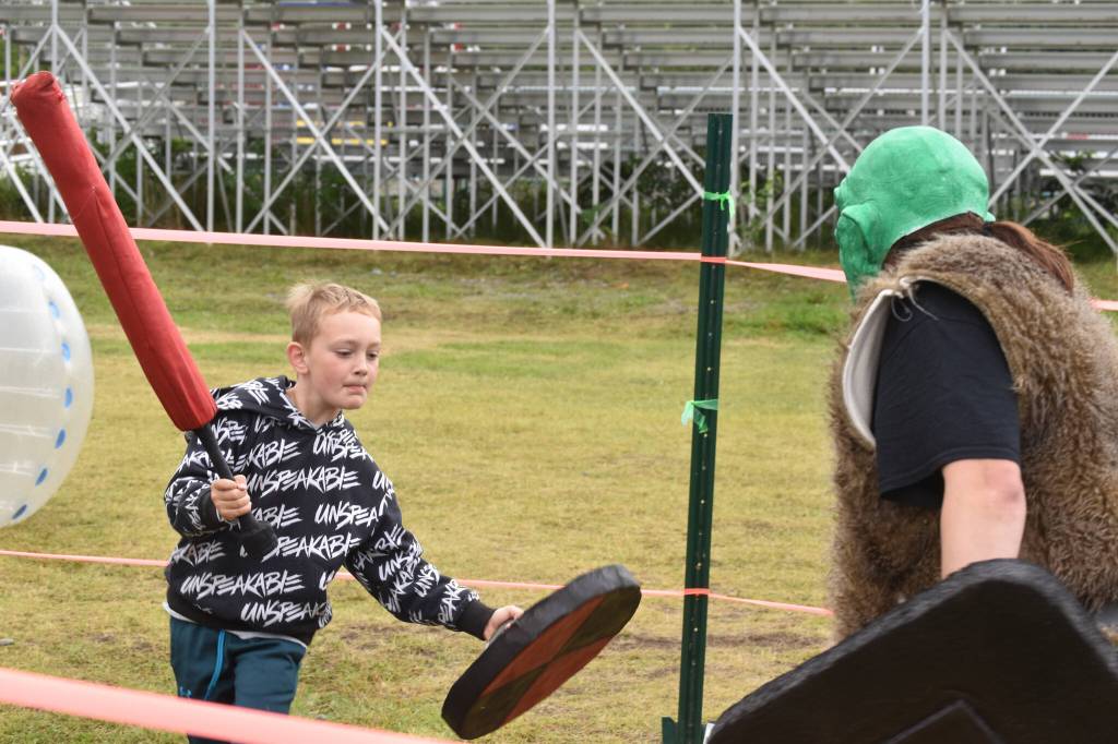 Fischer Klodt dodges the swing of a goblins sword at the Kenai Peninsula Fair on Aug. 12, 2022, in Ninilchik, Alaska. (Jake Dye/Peninsula Clarion)