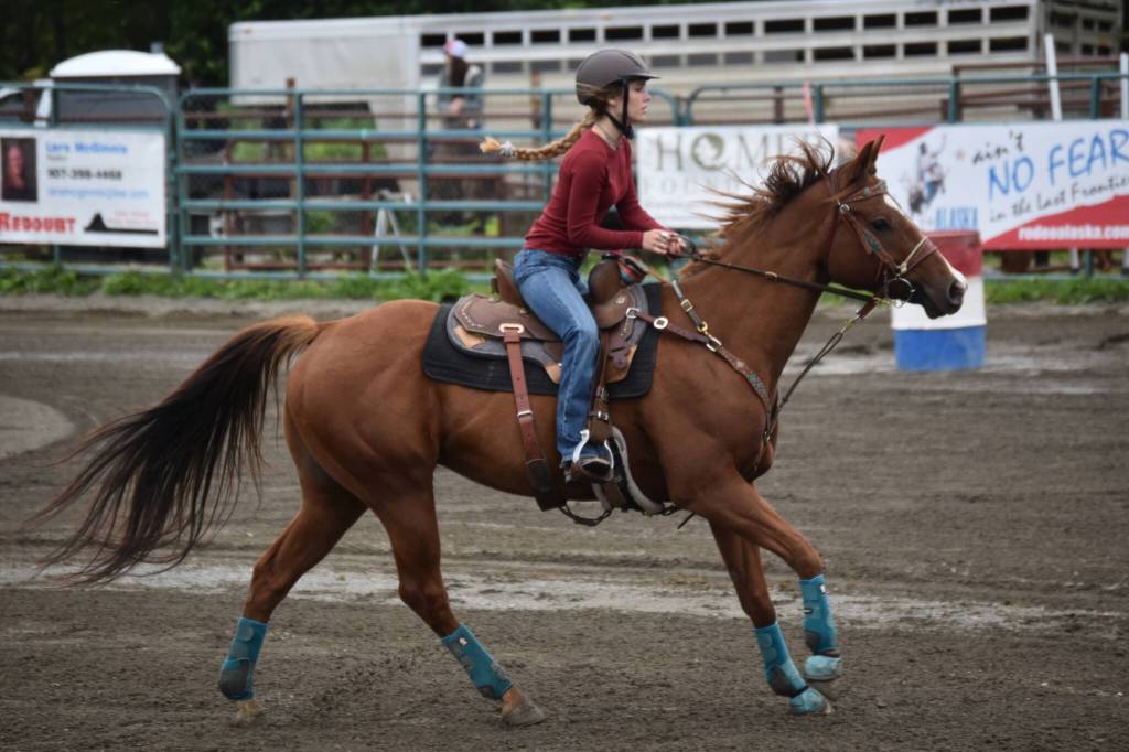 Evelyn Cooley competes in the barrel race at the Kenai Peninsula Fair on Aug. 12, 2022, in Ninilchik, Alaska. (Jake Dye/Peninsula Clarion)
