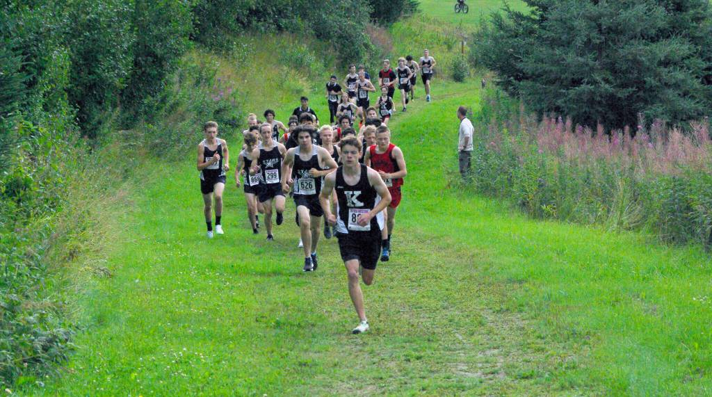 Kenai Central junior Greg Fallon takes the lead for good at the Kenai-Soldotna dual meet Monday, Aug. 15, 2022, at Tsalteshi Trails just outside of Soldotna, Alaska. (Photo by Jeff Helminiak/Peninsula Clarion)