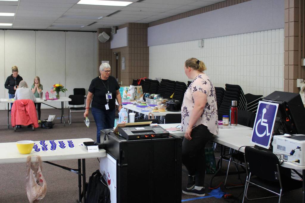 Pollworkers Carol Louthan (center) and Harmony Bolden (right) work at the Soldotna Regional Sports Complex on Tuesday, Aug. 16, 2022 in Soldotna, Alaska. (Ashlyn OHara/Peninsula Clarion)