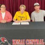 James Sparks, center, signs a National Letter of Intent with his parents, Angela and Jacob Sparks, on Tuesday, Aug. 16, 2022. (Photo provided)