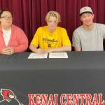 James Sparks, center, signs a National Letter of Intent with his parents, Angela and Jacob Sparks, on Tuesday, Aug. 16, 2022. (Photo provided)