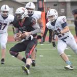Kenai Central quarterback Rock Riggle scrambles against North Pole on Saturday, Aug. 20, 2022, at Ed Hollier Field at Kenai Central High School in Kenai, Alaska. (Photo by Jeff Helminiak/Peninsula Clarion)