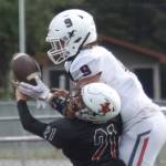 Kenai Central's Owen Whicker breaks up a pass intended for North Pole's Gabe Hollett on Saturday, Aug. 20, 2022, at Ed Hollier Field at Kenai Central High School in Kenai, Alaska. (Photo by Jeff Helminiak/Peninsula Clarion)