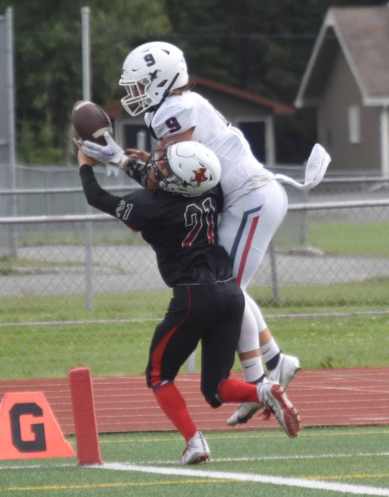 Kenai Centrals Owen Whicker breaks up a pass intended for North Poles Gabe Hollett on Saturday, Aug. 20, 2022, at Ed Hollier Field at Kenai Central High School in Kenai, Alaska. (Photo by Jeff Helminiak/Peninsula Clarion)