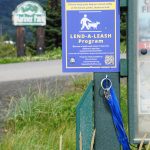 Leashes to lend hang from a kiosk at Mariner Park on Friday, Aug. 12, 2022, in Homer, Alaska. (Photo by Michael Armstrong/Homer News)
