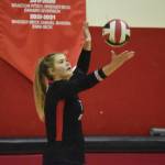 Emma Beck serves the volleyball on Aug. 25, 2022, in Kenai, Alaska. (Jake Dye/Peninsula Clarion)