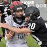 Eielsons Evan Brown is tackled by Nikiskis Wyatt Maguire on Saturday, Aug. 27, 2022, at Nikiski High School in Nikiski, Alaska. (Photo by Jeff Helminiak/Peninsula Clarion)