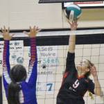 Kenai Centrals Camilla Gonzalez attacks on Sitkas Dalila Callahan on Saturday, Aug. 27, 2022, at the Shayna Pritchard Memorial Volleyball Tournament at Nikiski High School in Nikiski, Alaska. (Photo by Jeff Helminiak/Peninsula Clarion)