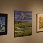 Artwork donated for the Harvest Auction hangs at the Kenai Art Center on Tuesday, Aug. 30, 2022, in Kenai, Alaska. (Jake Dye/Peninsula Clarion)