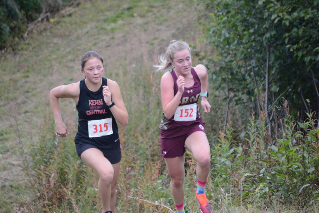 Emilee Wilson, left, of Kenai duels with Megan Nelson, right, of Grace Christian on the last hill of the Homer Invite on Friday, Sept. 2, 2022, at the Lookout Mountain Trails near Homer, Alaska. Nelson took fourth by just 4.23 seconds. (Photo by Michael Armstrong/Homer News)