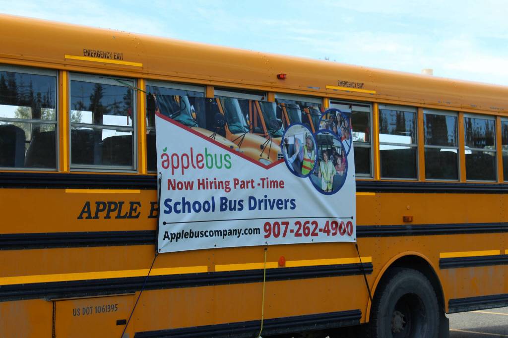 A school bus advertises driver positions outside of Kenai Central High School on Wednesday, Aug. 10, 2022, in Kenai, Alaska. Multiple Kenai Peninsula Borough School District bus routes will be consolidated beginning next week as it faces rising prices and a labor shortage. (Ashlyn OHara/Peninsula Clarion)