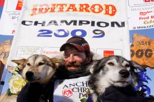 Lance Mackey sits with his lead dogs Larry, right, and Maple after crossing the finish line of the Iditarod Trail Sled Dog Race on March 18, 2009, in Nome, Alaska, to win his third Iditarod in a row. Mackey, a four-time Iditarod Trail Sled Dog Race winner and one of mushings most colorful and accomplished champions who also suffered from health and drug issues, died Wednesday, Sept. 7, 2022, his father and kennel announced on Facebook. He was 52. (AP Photo/Al Grillo, File)