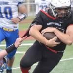 Kenai Central's William Wilson tries to break free of Kodiak's Connor Hughes on Saturday, Sept. 10, 2022, at Ed Hollier Field at Kenai Central High School in Kenai, Alaska. (Photo by Jeff Helminiak/Peninsula Clarion)