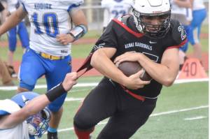 Kenai Central's William Wilson tries to break free of Kodiak's Connor Hughes on Saturday, Sept. 10, 2022, at Ed Hollier Field at Kenai Central High School in Kenai, Alaska. (Photo by Jeff Helminiak/Peninsula Clarion)