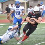 Kenai Centrals William Wilson tries to break free of Kodiaks Connor Hughes on Saturday, Sept. 10, 2022, at Ed Hollier Field at Kenai Central High School in Kenai, Alaska. (Photo by Jeff Helminiak/Peninsula Clarion)