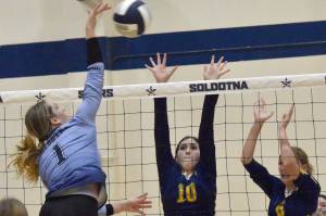 Soldotna's Katelyn Morrison attacks on Homer's Alivia Fefelov and Goldie Hill on Tuesday, Sept. 13, 2022, at Soldotna High School in Soldotna, Alaska. (Photo by Jeff Helminiak/Peninsula Clarion)