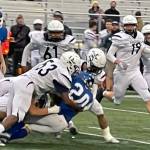 Palmers Kayson Asay is tackled by a trio of Stars during a 49-7 loss to Soldotna on Friday, Sept. 16, 2022, in Palmer, Alaska. (Photo by Jeremiah Bartz/Frontiersman)