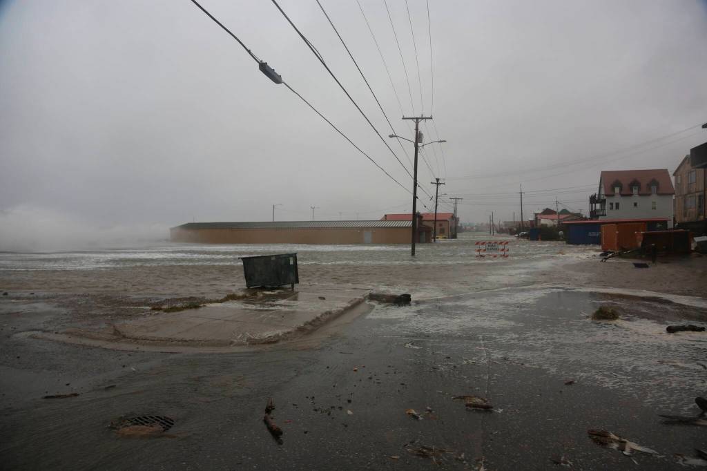 Water surrounds the mini convention center, which is also home to the finish of the Iditarod Trail Sled Dog Race, in Nome, Alaska, on Saturday, Sept. 17, 2022. Much of Alaskas western coast could see flooding and high winds as the remnants of Typhoon Merbok moved into the Bering Sea region. The National Weather Service says some locations could experience the worst coastal flooding in 50 years. (AP Photo/Peggy Fagerstrom)
