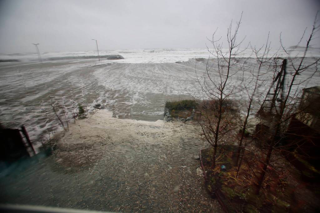 Water from the Bering Sea, pushed by high winds, rushes into a homes backyard in Nome, Alaska, on Saturday, Sept. 17, 2022. Much of Alaskas western coast could see flooding and high winds as the remnants of Typhoon Merbok moved into the Bering Sea region. The National Weather Service says some locations could experience the worst coastal flooding in 50 years. (AP Photo/Peggy Fagerstrom)