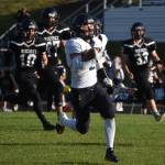 Homers Chris Martishev runs with the ball, pursued by Nikiskis James Hemphill, Jakeup Martin and Sam Yerkes, on Friday, Sept. 23, 2022 at Nikiski High School in Nikiski, Alaska. (Jake Dye/Peninsula Clarion)