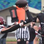 Kenai Central quarterback Bridger Beck throws under pressure from Houstons Keldin Nicoll on Saturday, Sept. 25, 2022, at Ed Hollier Field at Kenai Central High School in Kenai, Alaska. (Photo by Jeff Helminiak/Peninsula Clarion)