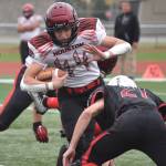 Houstons Mark Kudryn takes on a tackle from Kenai Centrals Owen Whicker on Saturday, Sept. 24, 2022, at Ed Hollier Field at Kenai Central High School in Kenai, Alaska. (Photo by Jeff Helminiak/Peninsula Clarion)