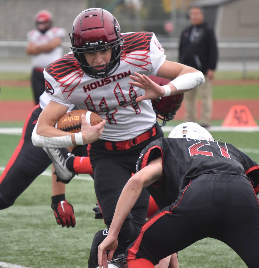 Houstons Mark Kudryn takes on a tackle from Kenai Centrals Owen Whicker on Saturday, Sept. 24, 2022, at Ed Hollier Field at Kenai Central High School in Kenai, Alaska. (Photo by Jeff Helminiak/Peninsula Clarion)