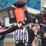 Kenai Central quarterback Bridger Beck throws under pressure from Houston's Keldin Nicoll on Saturday, Sept. 25, 2022, at Ed Hollier Field at Kenai Central High School in Kenai, Alaska. (Photo by Jeff Helminiak/Peninsula Clarion)
