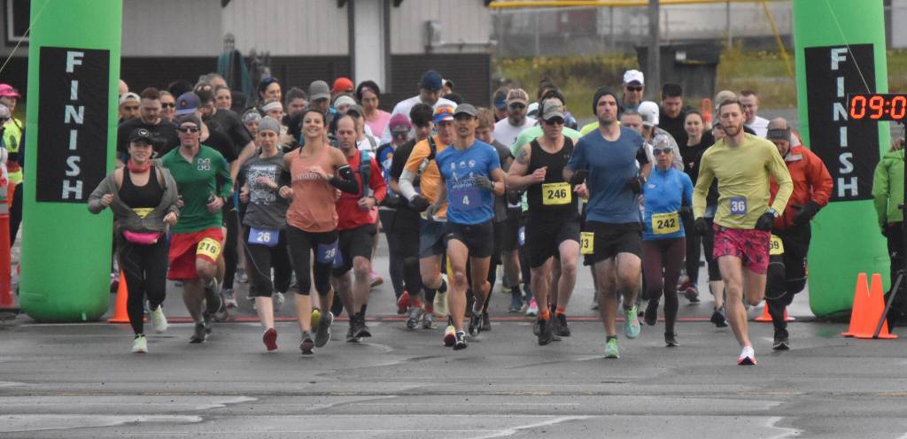 Marathon and half marathon runners begin the Kenai River Marathon on Sunday, Sept. 25, 2022, in Kenai, Alaska. At the front are womens marathon winner Amanda Cherok (28), mens half marathon winner Lee Frey (third from right), womens half marathon winner Kristin Davis (242) and mens marathon winner and new event record holder Lars Arneson (36).