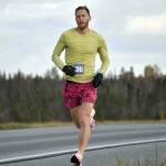 Lars Arneson runs to victory and a new event record in the Kenai River Marathon on Sunday, Sept. 25, 2022, in Kenai, Alaska. (Photo by Jeff Helminiak/Peninsula Clarion)
