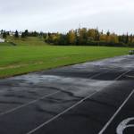 Water pools on a warped track at Nikiski Middle/High School on Monday, Sept. 19, 2022, in Nikiski, Alaska. The track is one of several projects in a bond package Kenai Peninsula voters will consider during the Oct. 4 municipal election next month. (Ashlyn OHara/Peninsula Clarion)