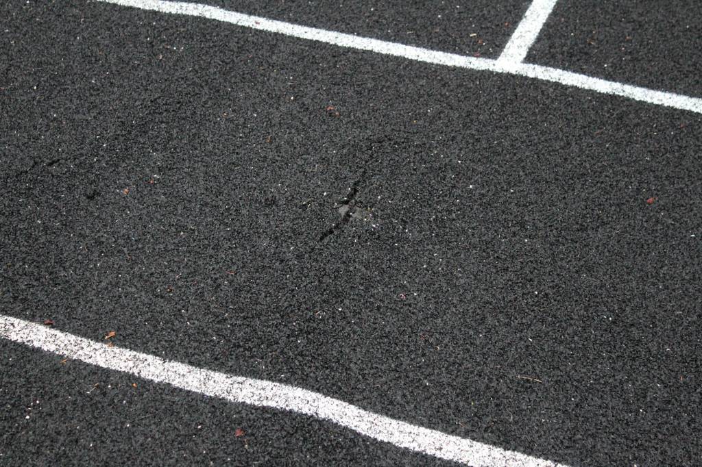 A crack warps the track at Nikiski Middle/High School on Monday, Sept. 19, 2022, in Nikiski, Alaska. The track is one of several projects in a bond package Kenai Peninsula voters will consider during the Oct. 4 municipal election next month. (Ashlyn OHara/Peninsula Clarion)