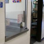 Notes are affixed to the cafeteria window, through which Principal Vaughn Dosko estimates 60% of students are given meals every day, at Kenai Middle School on Wednesday, Sept. 21, 2022, in Kenai, Alaska. (Ashlyn OHara/Peninsula Clarion)