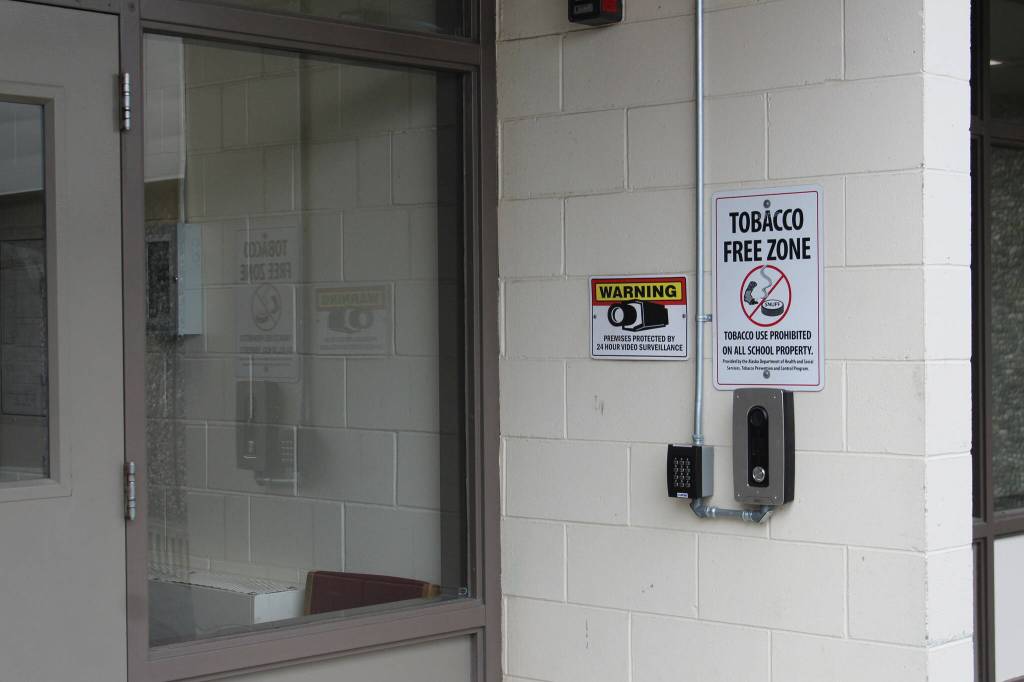 A camera and doorbell are mounted outside of the entrance to Kenai Middle School on Wednesday, Sept. 21, 2022, in Kenai, Alaska. (Ashlyn OHara/Peninsula Clarion)