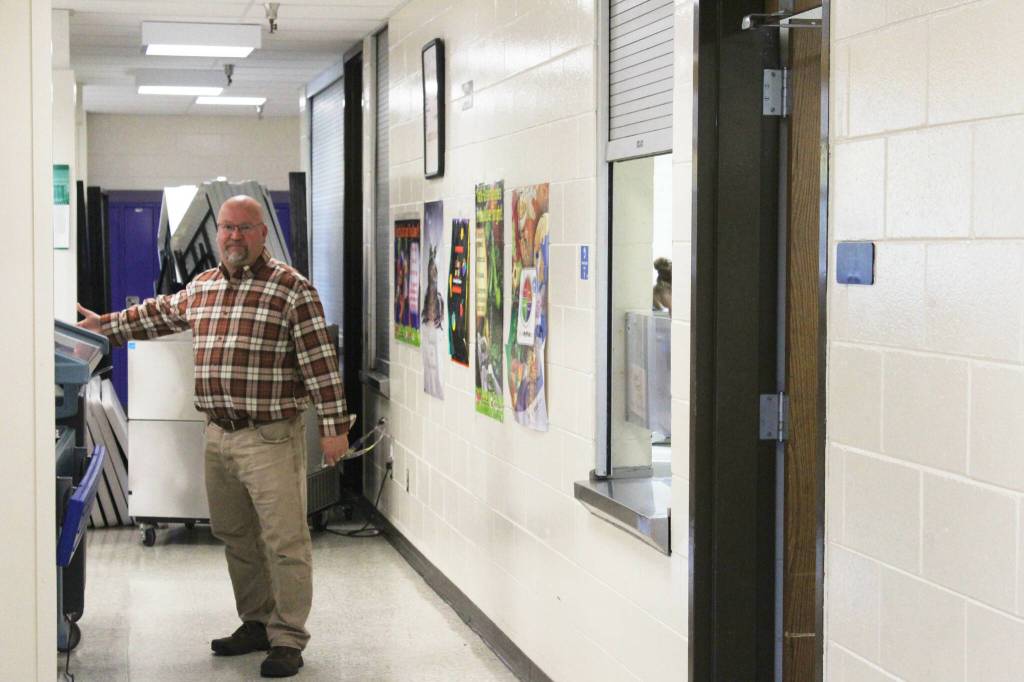 Kenai Middle School Principal Vaughn Dosko gestures toward a cart used to provide school lunch services on Wednesday, Sept. 21, 2022, in Kenai, Alaska. (Ashlyn OHara/Peninsula Clarion)