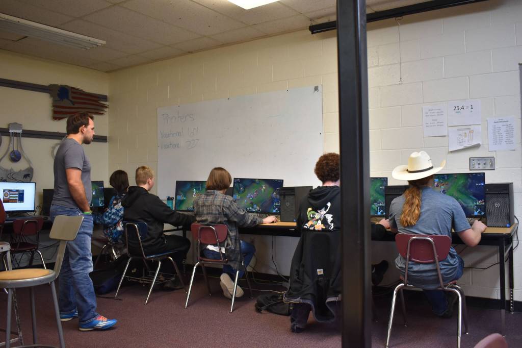 Coach Shane Lopez watches the Kenai Central High School League of Legends team compete against Anchorage Christian Schools on Tuesday, Sept. 23, 2022, at Kenai Central High School in Kenai, Alaska. (Jake Dye/Peninsula Clarion)