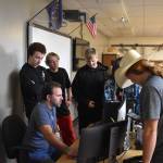 Members of Kenai Central High School Esports gather around coach Shane Lopez before their League of Legends match Tuesday, Sept. 27, 2022, at Kenai Central High School in Kenai, Alaska. (Jake Dye/Peninsula Clarion)