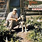 Photo courtesy of the Mona Painter Collection 
William Big Bill Roberts, who operated the Russian River Rendezvous in the mid-1950s, poses with his dog near the front door of the lodge.