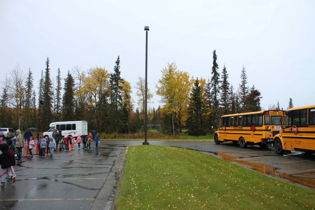 Students wait to be picked up near school buses outside of Mountain View Elementary School on Thursday, September 29, 2022, in Kenai, Alaska. A bond package up for consideration by Kenai Peninsula Borough voters on Oct. 4 would fund improvements to the schools traffic flow. (Ashlyn OHara/Peninsula Clarion)
