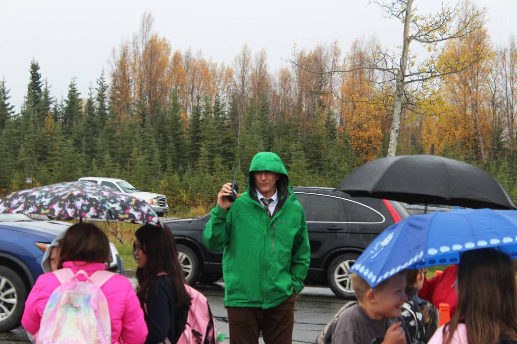 Mountain View Elementary School Principal Karl Kircher (green) helps direct student pick up traffic at the end of the school day on Thursday, Sept. 29, 2022, in Kenai, Alaska. (Ashlyn OHara/Peninsula Clarion)