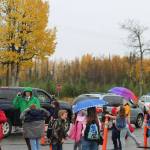 Mountain View Elementary School Principal Karl Kircher (green) helps direct student pick up traffic at the end of the school day on Thursday, Sept. 29, 2022, in Kenai, Alaska. (Ashlyn OHara/Peninsula Clarion)