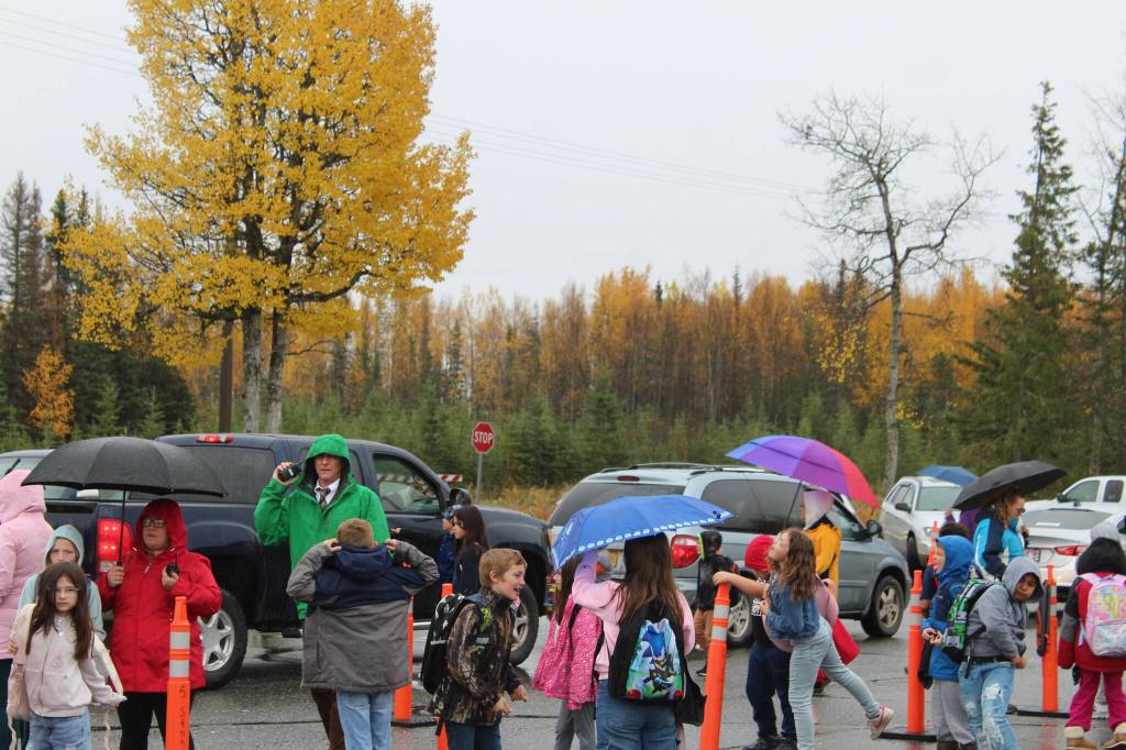 Mountain View Elementary School Principal Karl Kircher (green) helps direct student pick up traffic at the end of the school day on Thursday, Sept. 29, 2022, in Kenai, Alaska. (Ashlyn OHara/Peninsula Clarion)
