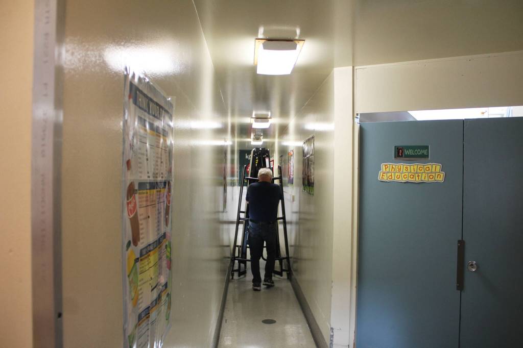Staff move tables ahead of lunchtime at Soldotna Elementary School on Friday, Sept. 30, 2022, in Soldotna, Alaska. (Ashlyn OHara/Peninsula Clarion)